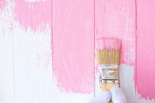 Arbor Greene House Painter Using Brush To Cover White Wall with Pink