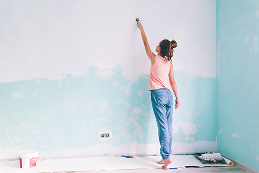 Lady from Channelside FL Painting a House White