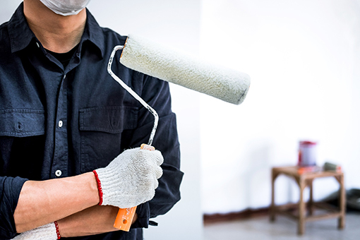 Channelside House Painter Showing Roller Brush Covered with White Paint