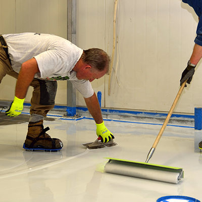 House Painter Coating a Garage Floor in Tampa FL